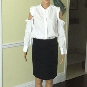 White top and black with thin white stripe skirt